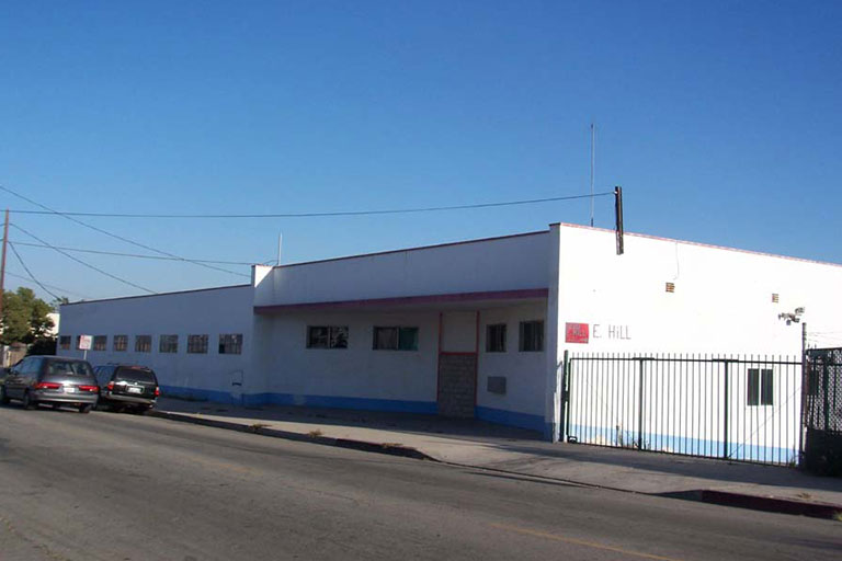White building with blue trim, street view.