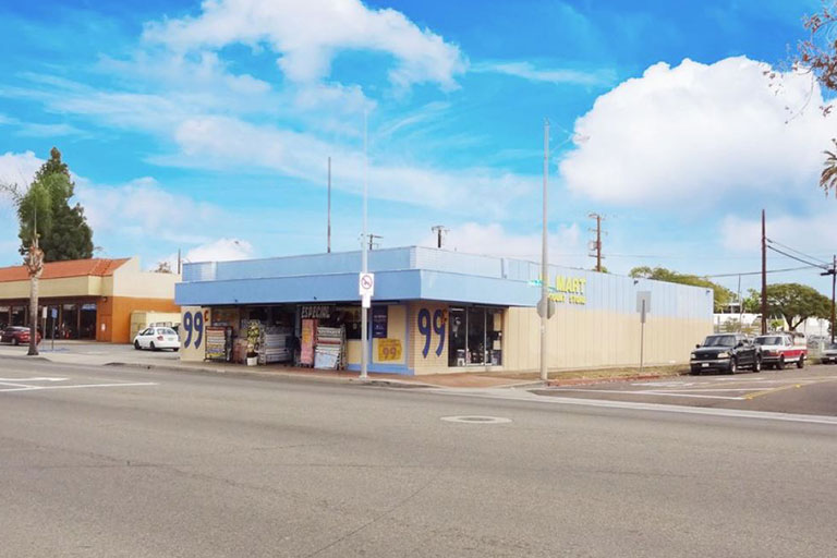 Corner store with blue and beige exterior.