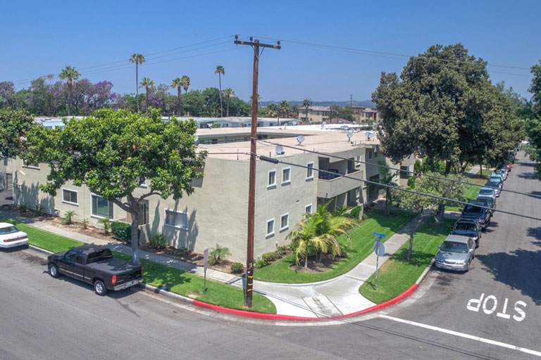Apartment building on a tree-lined street.