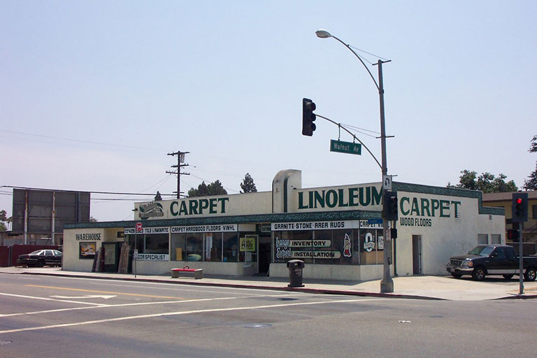 Carpet and linoleum store on street corner.