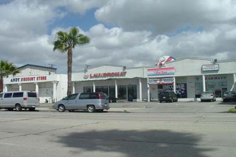 Small strip mall with various storefronts.