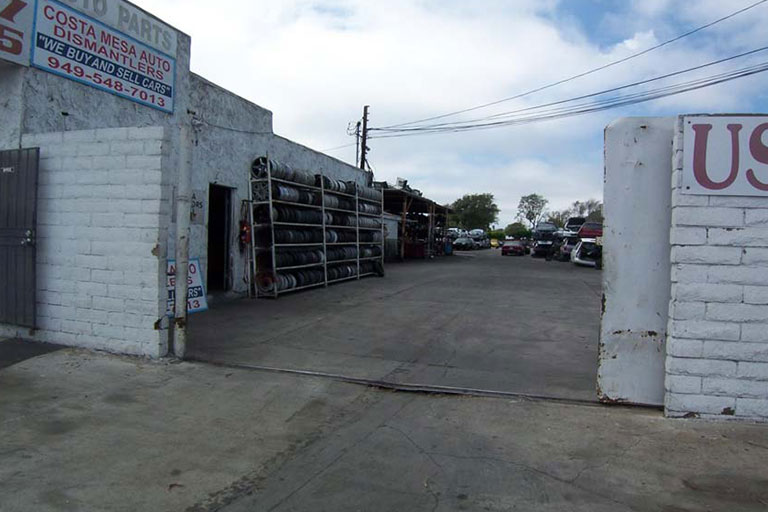 Auto parts lot with stacked tires.