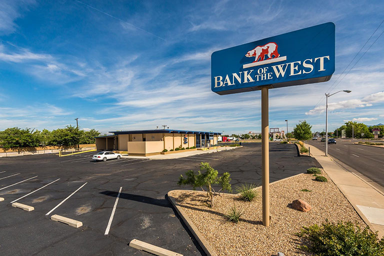 Bank with parking lot and blue sky.