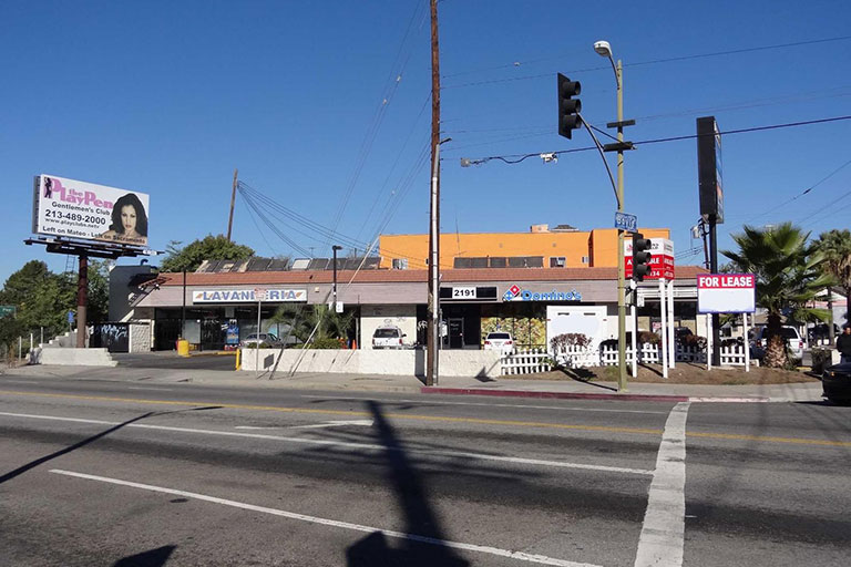 Street view of commercial buildings and signs.