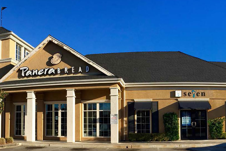 Panera Bread storefront with clear blue sky.
