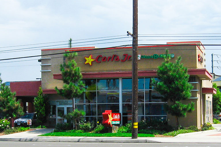 Fast-food restaurant with drive-thru and signage.