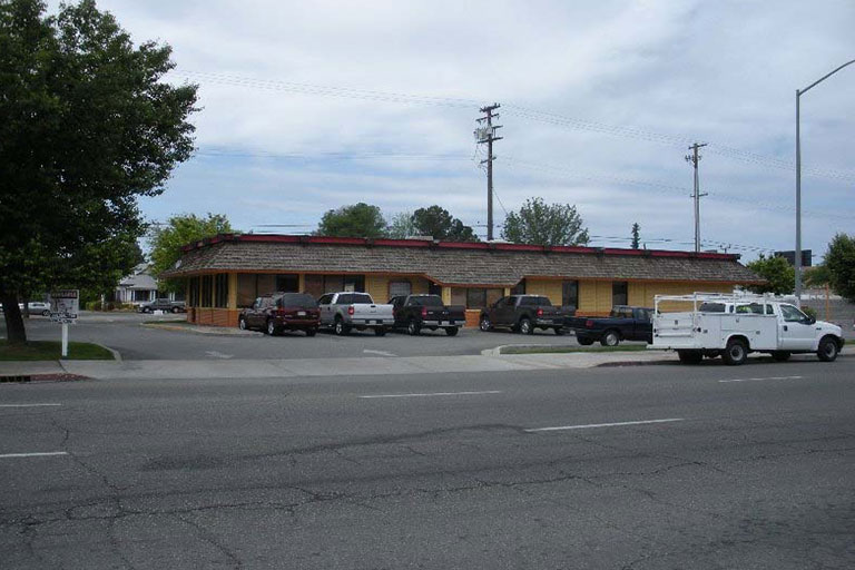 Parking lot in front of a building.