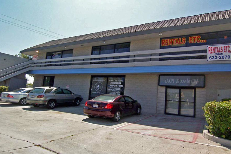 Office building with parked cars outside.