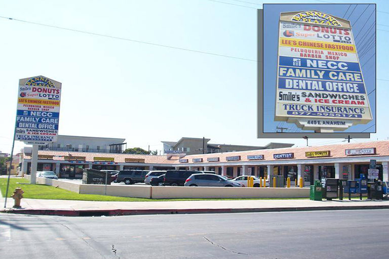 Shopping center with various store signs.
