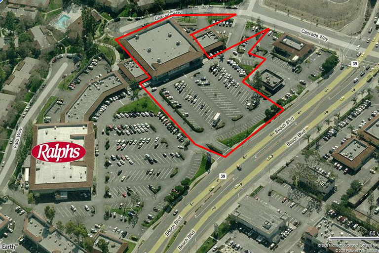 Aerial view of shopping center and parking lot.