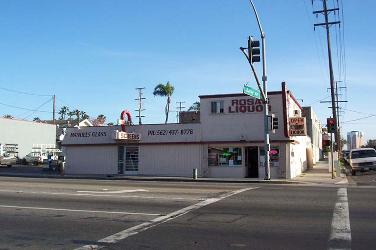 Street corner with liquor store and glass shop.