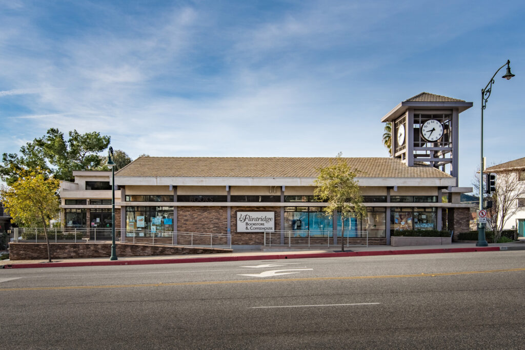 Building with clock tower on a street.
