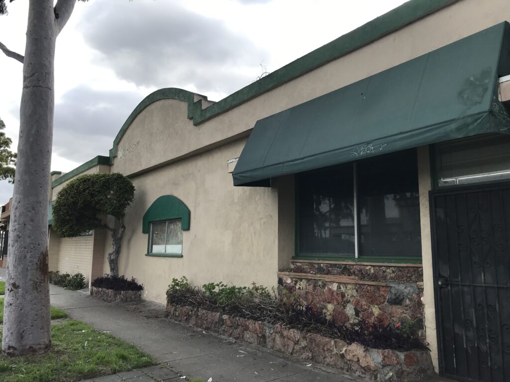 Building with green awnings and stone accents.