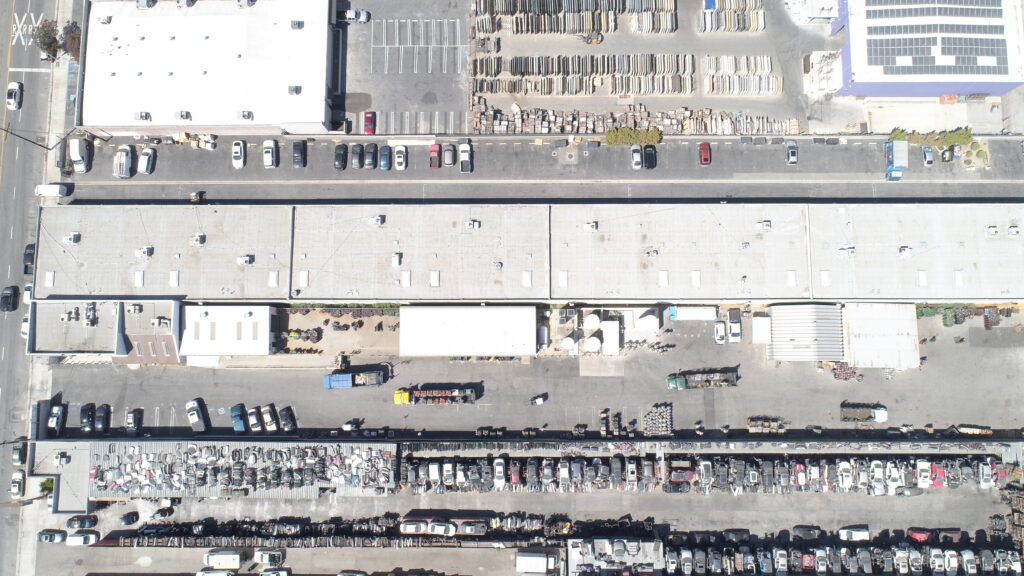 Aerial view of industrial area with vehicles.