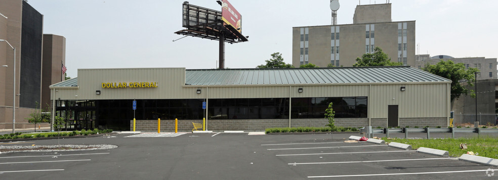 Empty parking lot in front of building.