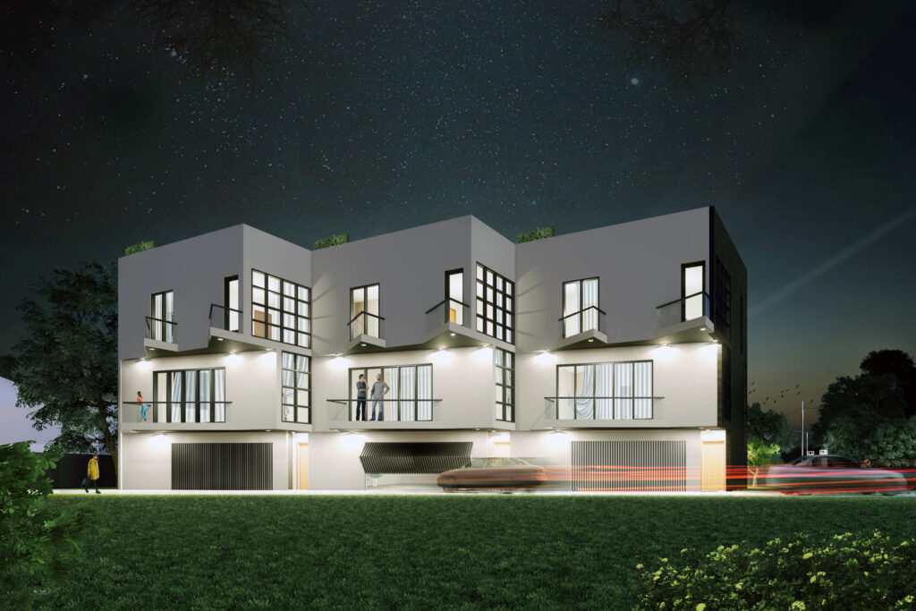 Modern building exterior at night with lights.