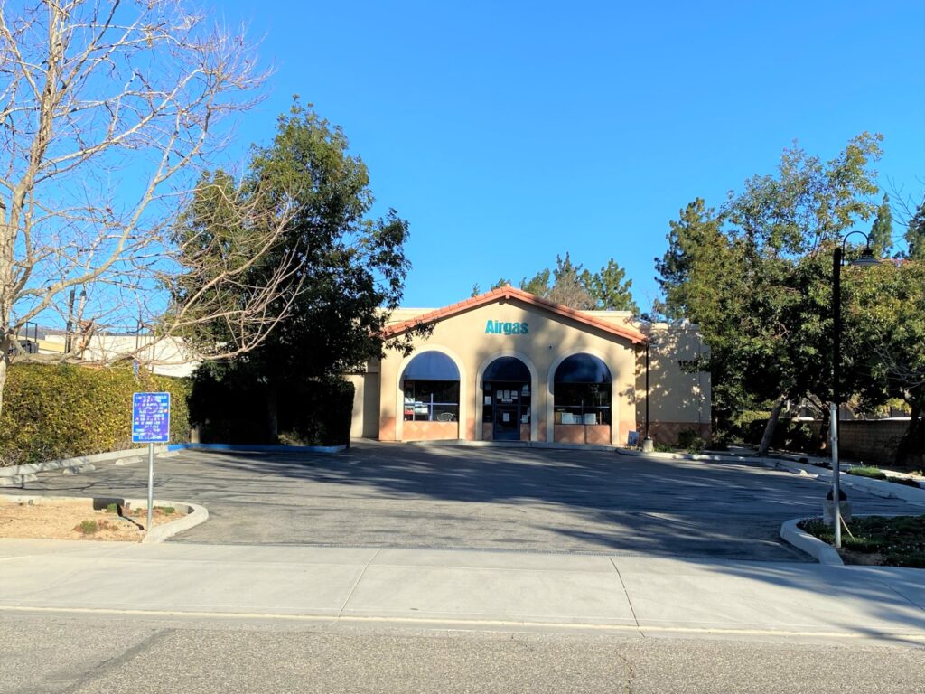 Building with arched windows and empty parking.